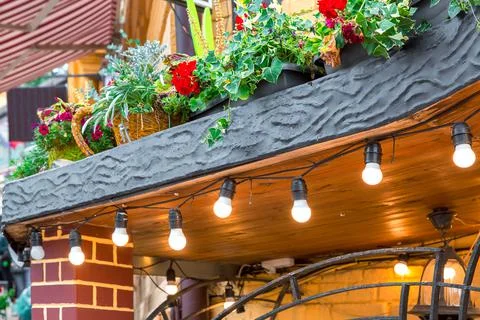 Decorative elements of the facade decoration of building with flowerpots. Stock Photos