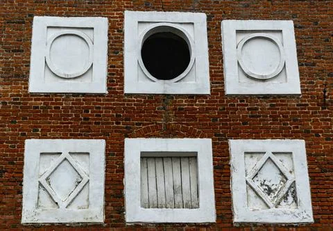 Decorative elements on the red brick wall of the ancient tower. Elements of a Stock Photos