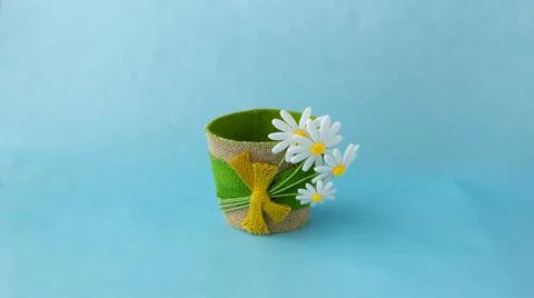 Decorative empty flower pot made of felt, on a blue solid surface Stock Photos
