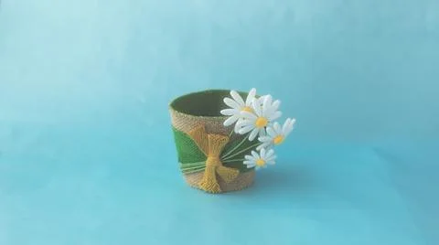 Decorative empty flower pot made of felt, on a blue solid surface Stock Photos