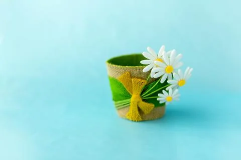 Decorative empty flower pot made of felt, on a blue solid surface Stock Photos