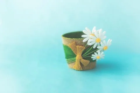 Decorative empty flower pot made of felt, on a blue solid surface Stock Photos
