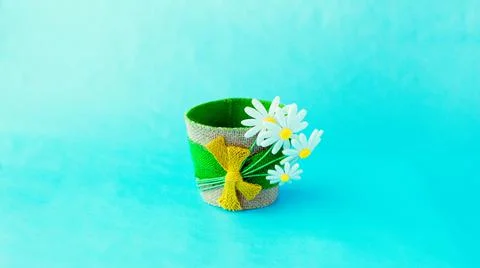 Decorative empty flower pot made of felt, on a blue solid surface Stock Photos