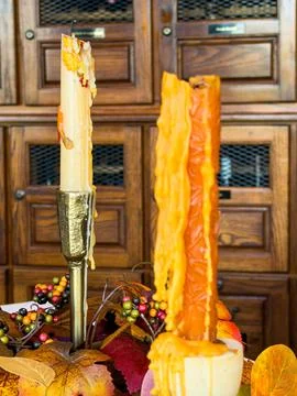 Decorative Fall Candles with Dripping Melted Wax and Autumn Leaves Stock Photos