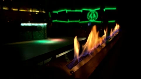 Decorative fire burns in the dark room of the night club. Empty dance floor Stock Footage 129486284