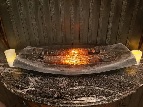 Decorative fireplace with mock-up. Artificial fire on wood Stock Photos