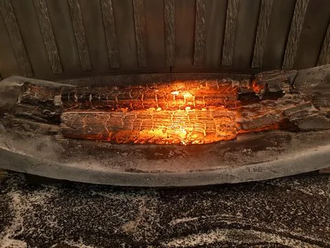 Decorative fireplace with mock-up. Artificial fire on wood Stock Photos