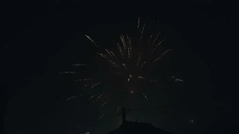 Decorative fireworks are set off between the houses. Happy new year. Countryside Stock Footage 196206520