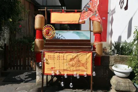 Decorative fish-themed display with lanterns, tassels, fabric panels, and h.. Stock Photos