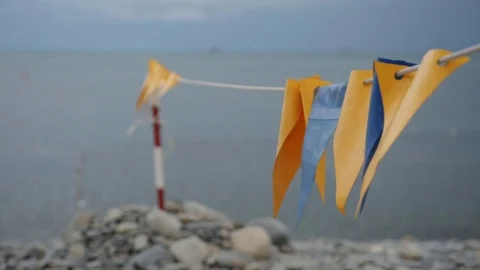 Decorative flags fluttering in the wind on the beach. Stock Footage 78487093