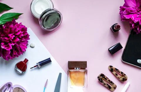 Decorative flat lay composition with cosmetics and flowers. Top view Stock Photos