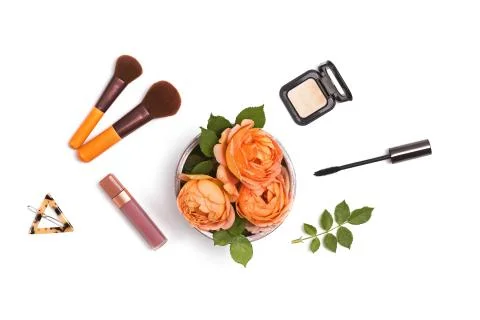Decorative flat lay composition with lipstick, mascara and flowers. Stock Photos