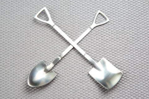 Decorative fork and spoons in the form of spades on a gray background. food.. Stock Photos