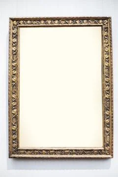 Decorative frame with a carved floral pattern on a gray background. Mockup .. Stock Photos