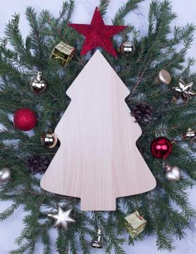 Decorative frame in the shape of a Christmas tree with toys on the background Stock Photos