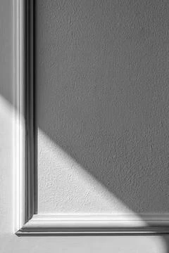 Decorative frame on a textured wall with shadow. Stock Photos