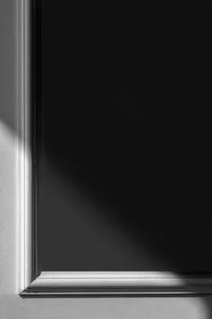 Decorative frame on the wall with shadow. Black space for text Stock Photos