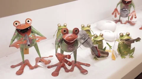 Decorative Frogs standing on store shelf Stock Footage 53079915