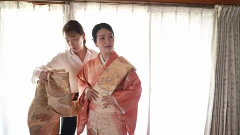 Decorative front panel added to an orange kimono Stock-Footage 344014754