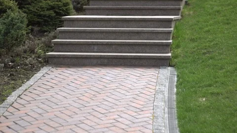 Decorative garden with walkways, steps, a bridge and a fountain on a sunny sprin Stock Footage 107147013