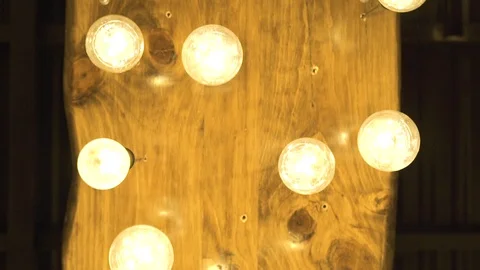 Decorative glowing bulbs hanging on ceiling in dark room. Lighting lamp from Stock Footage 101769525