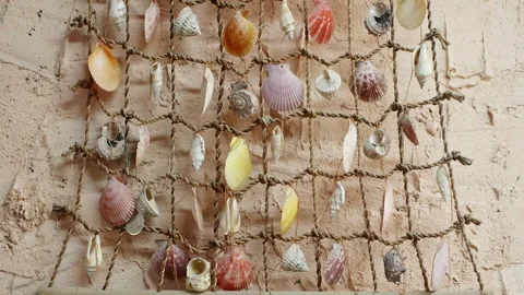Decorative hanging made of seashells against old wall Stock Footage 291497850