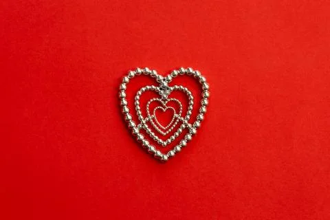 Decorative heart on a red background, flat lay, conceptual minimalism. Stock Photos