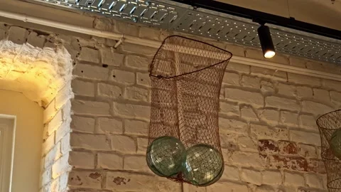 Decorative industrial-style hanging light fixtures green glass spheres housed Stock Footage 334691252