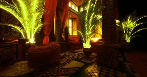 Decorative interior with vibrant palm trees illuminated at sunset 库存影片 318136062