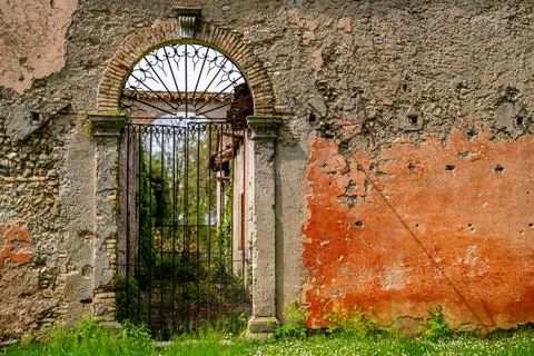 Decorative Iron Gate in Aged Stone Arch Stock Photos