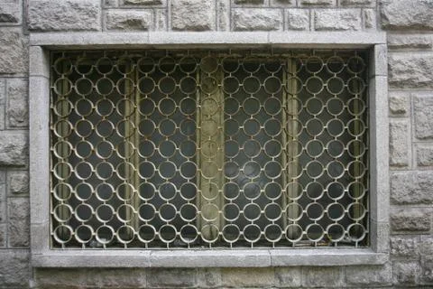 Decorative iron window pattern, metal protection on the window, metal net cir Stock Photos