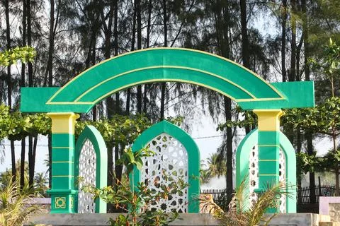 Decorative Islamic style arch structure painted in green, yellow, and white Stock Photos