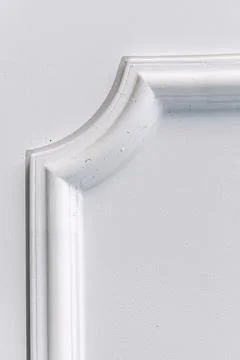 Decorative item made of white plaster on ceiling close-up. Relief stucco in.. Stock Photos