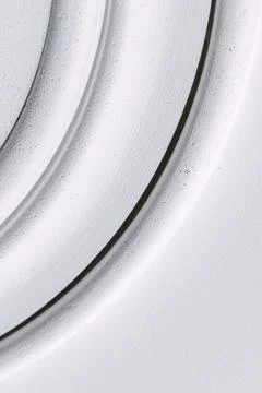 Decorative item made of white plaster on ceiling close-up. Relief stucco in.. Stock Photos
