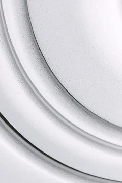 Decorative item made of white plaster on ceiling close-up. Relief stucco in.. Stock Photos
