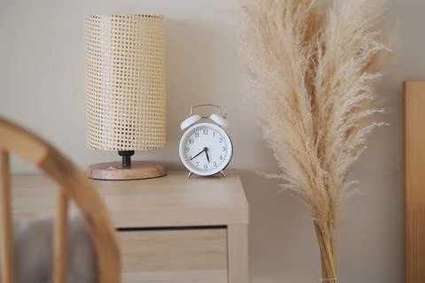 Decorative items on a bedside table in a room Stock Photos