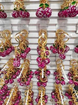 Decorative key chains in the form of round cherries with  shiny stones Stock Photos
