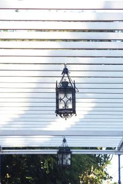 Decorative lantern hanging in the arbor Stock-Fotos