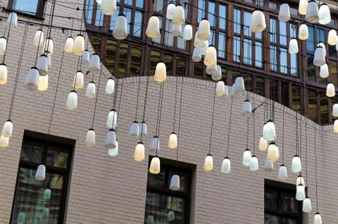Decorative lanterns on strings against the facade of a modern building-concep Foto stock