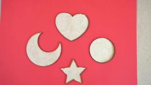 Decorative laser-cut shapes displayed on a red surface 스톡 동영상 329588340