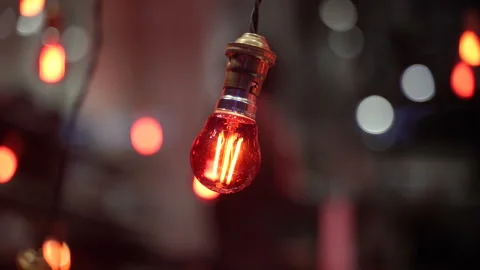 Decorative light bulbs with warm glow in evening atmosphere with bokeh backgr Stock Footage 335500560