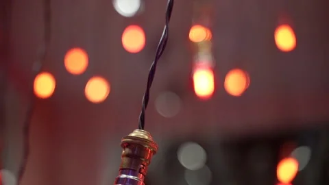 Decorative light bulbs with warm glow in evening atmosphere with bokeh backgr Stock Footage 335500668
