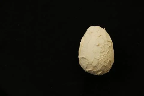 Decorative light egg on a dark background. Stock Photos