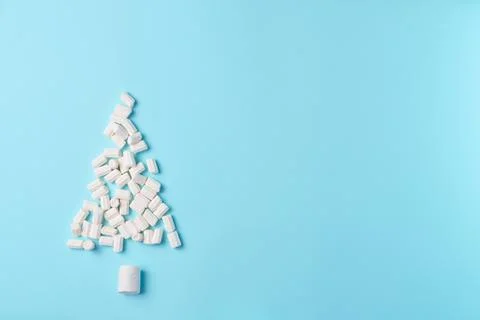 Decorative marshmallow tree on blue background from above. Christmas concep.. Stock Photos
