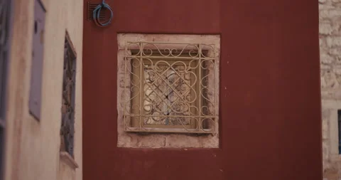 Decorative metal window grille on red facade in Rovinj Stock-Footage 334243589
