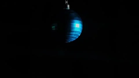 Decorative mirror ball with blue reflections rotating on a dark background. Stock Footage 256277567