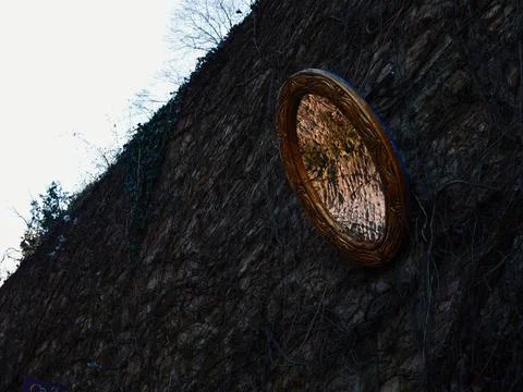 Decorative Mirror on Stone Wall Reflecting Nature Stock Photos