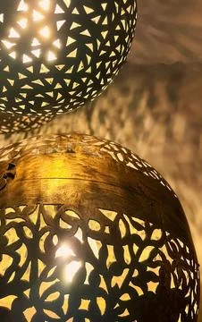 Decorative Moroccan Style Lanterns Casting Intricate Shadows on a Textured .. Stock Photos