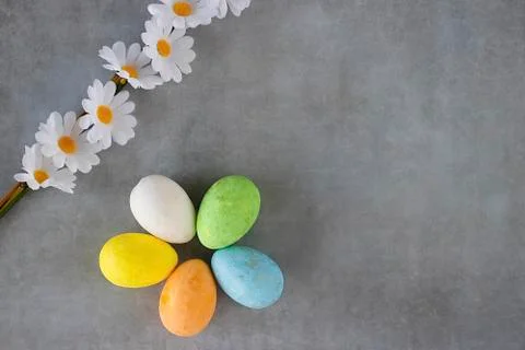 Decorative multi-colored eggs on a gray backgroun Stock Photos