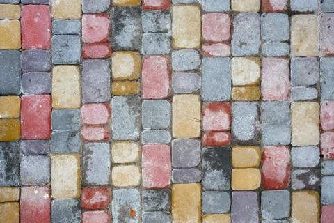 Decorative multi-colored tile for the sidewalk after the rain. Top view. Stock Photos